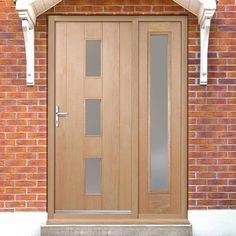 the front door is made of wood and has glass panels on each side, along with a brick wall behind it