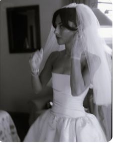 a woman wearing a wedding dress and veil