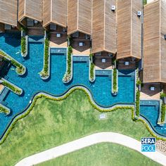 an aerial view of the resort pool and surrounding area with wooden loungings over it