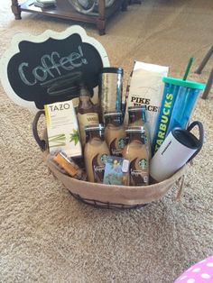 a basket filled with lots of different types of coffee and other items on the floor