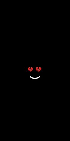 a black background with two red hearts in the dark