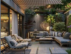 an outdoor living area with couches, tables and potted plants