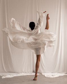 a woman in white is dancing on the floor