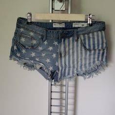 Bullhead Denim Co Low Rise Screen Printed And Cutoff American Flag Denim Shorts. Cotton/Spandex Blend With Fraying At The Hem. Waist Measures 16" Laying Flat And Length Measures 9". Rise Measures 9". Nwot American Flag Jean Shorts, Blue Stretch Cutoff Jean Shorts, Americana Style Denim Jean Shorts For Spring, Americana Denim Jean Shorts, Americana Style Denim Summer Bottoms, Summer Americana Denim Bottoms, American Flag Print Denim Jean Shorts, Denim American Flag Print Shorts For Spring, Denim Shorts With American Flag Print For Spring