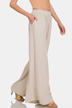 The Pleated Linen Blend Wide Leg Pants are a sophisticated and chic addition to your wardrobe. The pleated design adds a touch of elegance and movement to these wide-leg pants. Made from a linen blend fabric, they offer breathability and comfort for all-day wear. The wide-leg silhouette is both stylish and flattering, providing a relaxed yet polished look. Perfect for both casual and dressy occasions, these pants can be dressed up with heels or styled casually with sandals. Boho Pants, Sand Beige, Pantalon Large, Sweater Blouse, Polished Look, Womens Clothing Tops, Linen Blend, Plus Size Dresses, Leg Pants