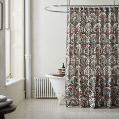 a bathroom with a bathtub, shower curtain and rug