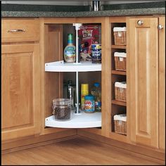 an open cabinet in a kitchen filled with food