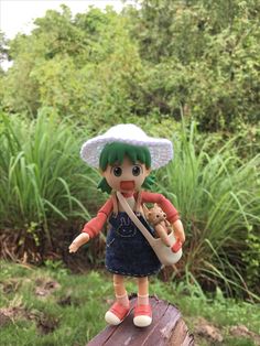 a doll is standing on a wooden post