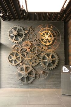 a large metal clock mounted to the side of a wall