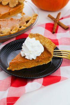 a slice of pumpkin pie with whipped cream on top