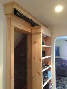 a room with a book shelf and mirror in it