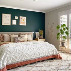 a bedroom with green walls and white bedding