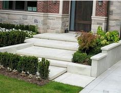 an outdoor garden with steps leading to the front door