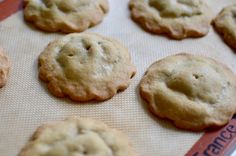 freshly baked cookies sitting on top of a cookie sheet in an oven tray, ready to be eaten