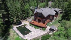 this is an aerial view of a house in the woods with lots of trees around it