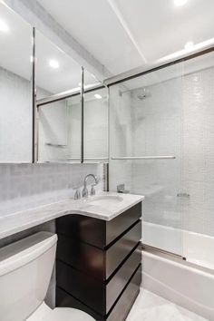 a bathroom with a sink, toilet and bathtub next to a walk in shower