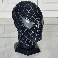 a black and white mask sitting on top of a table