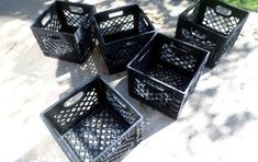 four black baskets are sitting on the sidewalk