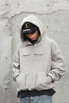 The Multi-Pocket Zipper Rivet Hoodie epitomizes the perfect fusion of casual comfort and utilitarian function. This hoodie is a testament to thoughtful design, featuring multiple pockets on the front, each secured with high-quality YKK zippers, ensuring both style and practicality. The pocket at the chest is further accentuated with rivet decorations, adding a touch of edginess to the piece. A deconstructed pocket on the left sleeve offers additional storage and a unique visual element. The cuff Unique Hoodies Design, Streetwear Hoodie Outfit, Headwear Fashion, Tiki Tiki, Hoodie Streetwear, Unique Hoodies, Common Ground, Fashion Videos, Tee Shirt Designs