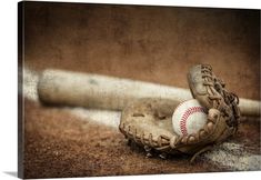 an old baseball glove with a ball on the ground in front of a bat canvas wall art print