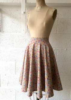 a mannequin with a dress on display in front of a white brick wall