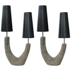 three lamps with black shades on them