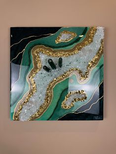 an abstract painting with gold and green colors