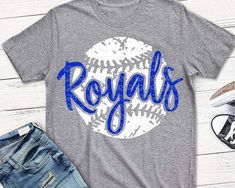 a gray shirt with the word royals on it next to denim shorts and sneakers,