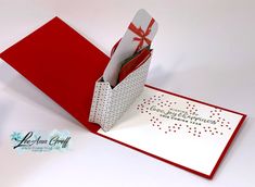 a red and white greeting card with envelope