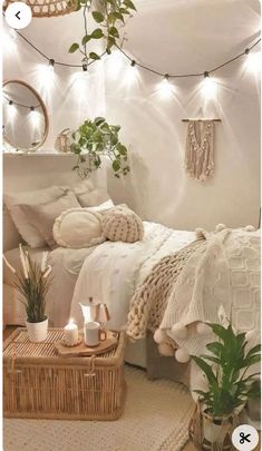 a white bedroom with plants and lights on the wall