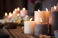 several lit candles sitting on top of a table