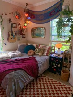 a room with a bed, guitar and other decorations