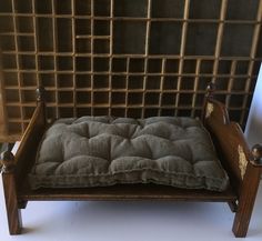 a small wooden bench with a cushion on it