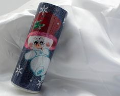 a blue and white tube with a snowman on it's side sitting on a white sheet