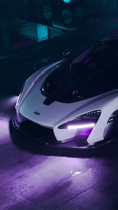 a white sports car with purple lights on it