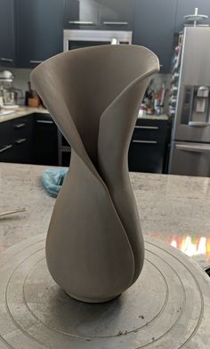 a vase sitting on top of a table in a kitchen