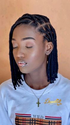 a woman with braids and piercing on her nose