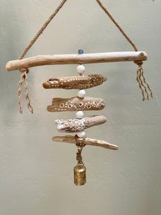 a wind chime made out of driftwood and beads