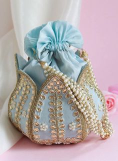 Introducing the Elegant Lotus Potli Bag by Byra, a masterpiece of traditional craftsmanship and contemporary design. This unique embroidered Indian bridal potli bag is an ideal accessory for weddings, engagements, bridesmaid gifts, and anniversary presents. Its intricate detailing and luxurious finish make it a standout piece that exudes elegance and sophistication. Description: Elegant Lotus Potli Bag - Unique Embroidered Indian Bridal Potli for Weddings, Engagements, Bridesmaid & Anniversary Gifts by Byra Material: Crafted from premium quality fabric, offering a rich and luxurious texture that enhances its elegant appearance. Design: Features exquisite lotus embroidery, symbolizing purity and beauty. The detailed needlework showcases the exceptional skill of our artisans, making each bag Lotus Potli Bag, Anniversary Presents, Potli Bag, Potli Bags, Anniversary Present, Indian Bridal, Gift Bags, Bridesmaid Gifts, Gift Bag