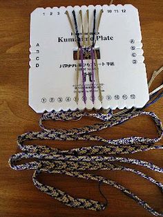 several pieces of white paper sitting on top of a wooden table next to some cords