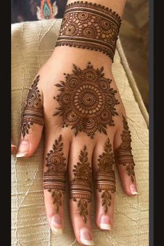 henna tattoo on the palm of a woman's hand