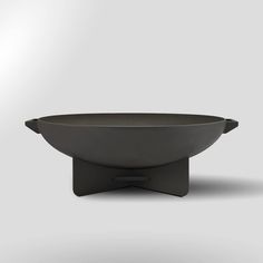 a black bowl sitting on top of a metal stand