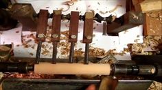 a machine that is making some kind of thing out of wood and other things around it