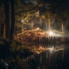 a group of people standing in front of a tent at night with lights on the trees