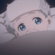 an anime character with blue eyes peeking out from behind a pillow