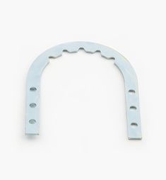 an arch made out of metal with holes in the middle on a white wall background