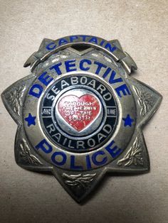 a police badge with a heart on the front and blue writing that says, i can't be effective