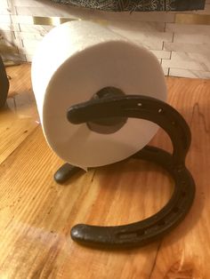 a roll of toilet paper on top of a wooden table