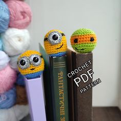 two crocheted book ends sitting next to each other on top of a bookshelf