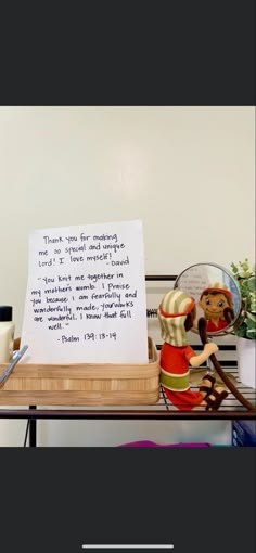 a wooden table topped with lots of clutter next to a white sign that says thank your customers